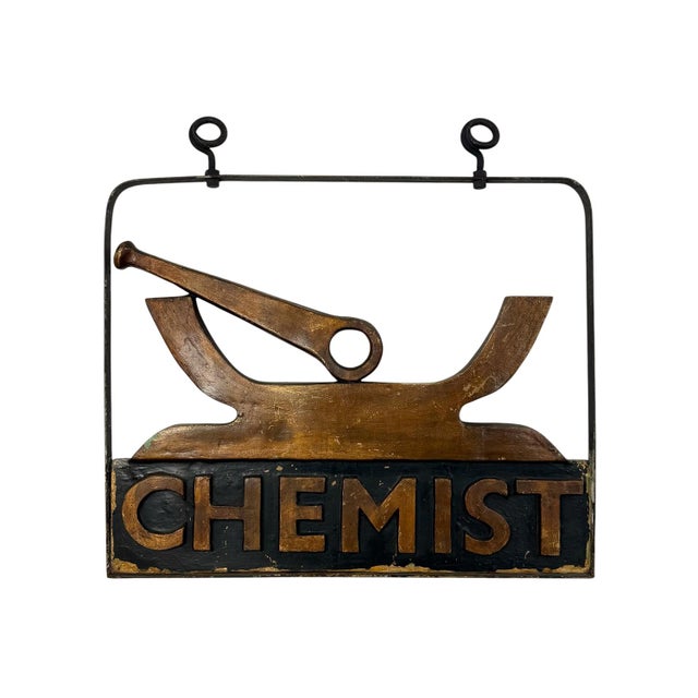 Unique vintage chemist or apothecary shop sign featuring a stylized mortar and pestle above bold “CHEMIST” lettering. The...