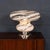 A striking italian table lamp dating to the 1970s, featuring a sculptural murano glass shade with bold white swirling...