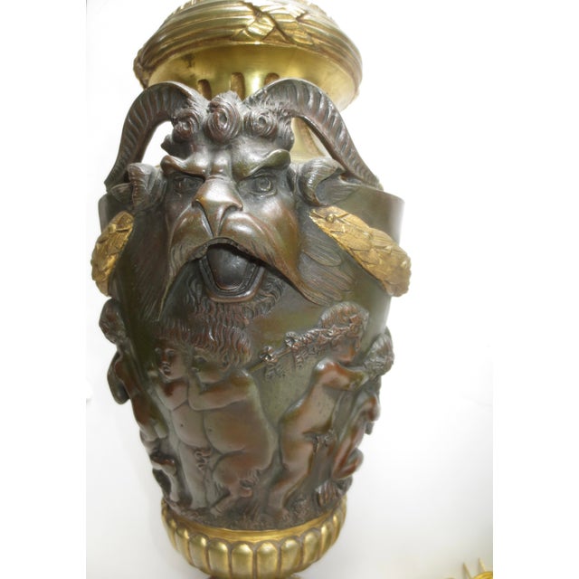 Very fine 19th century Italian cast bronze of garnatures mounted as lamps. The design of two grotesque faces on each...