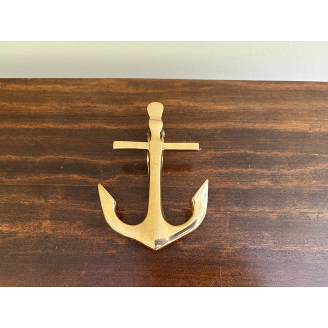 A handsome late-20th-century cast brass door knocker modeled as a traditional ship’s anchor. The clean, graphic silhouette...