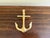 A handsome late-20th-century cast brass door knocker modeled as a traditional ship’s anchor. The clean, graphic silhouette...