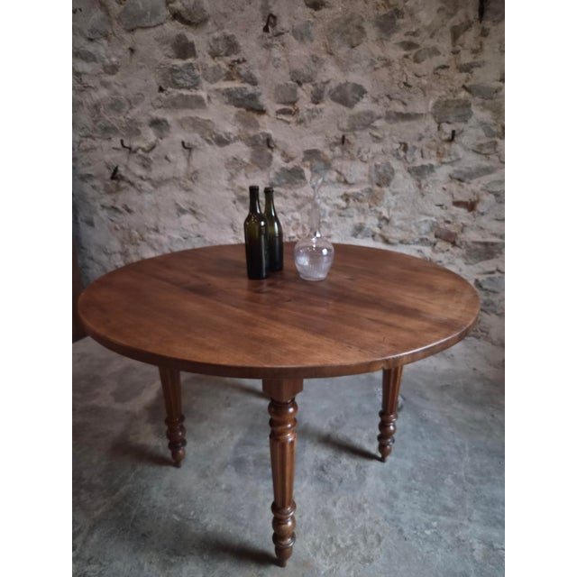 Antique French round dining table dating from the late 19th century, circa 1880–1900. The table is crafted in walnut and...