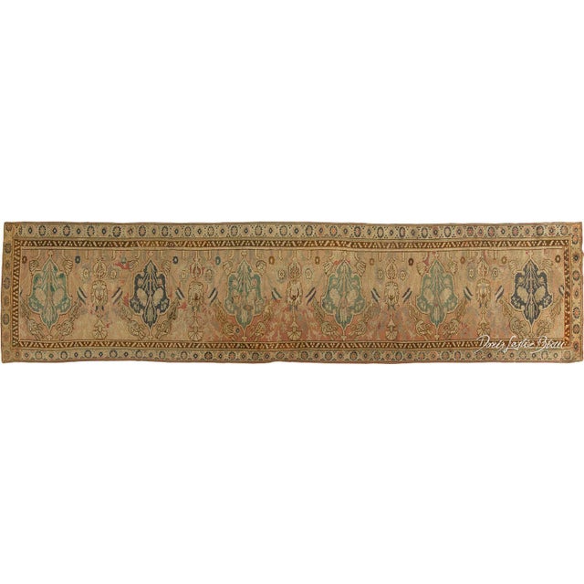 A 16th century Cairene antique runner, the abrashed dusty rose field with stylized leaves and rosettes overall around a...