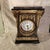 A substantial and highly decorative Neoclassical/Empire Revival mantel clock featuring richly patterned rose breccia...