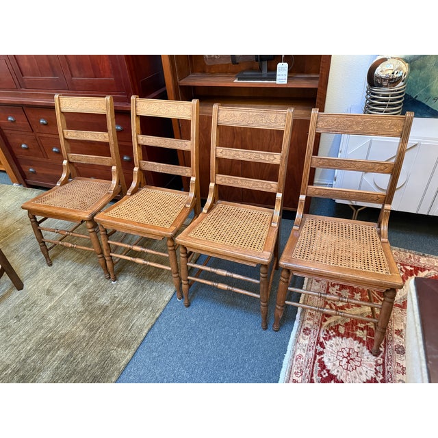 Design Plus Gallery presents a Set of Four Antique Ladder-back Dining Room Chairs from the Victorian Era. The chairs have...