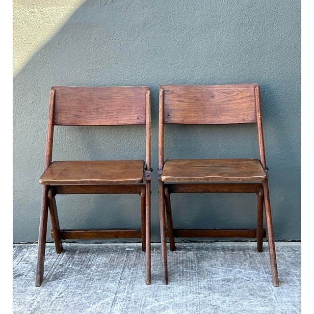 This handsome pair of vintage French folding chairs embodies the enduring charm of European rustic design. Crafted from...