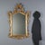Barocchetto style mirror crafted from carved and gilded wood, dating back to early 20th century Italy. The design features...