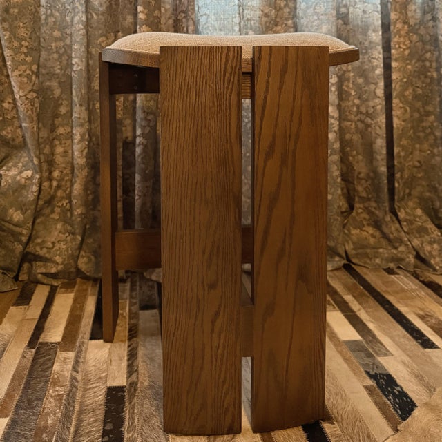 Four Hands Hoven backless counter stool featuring a sculptural oak frame and upholstered seat in Alcala Fawn performance...