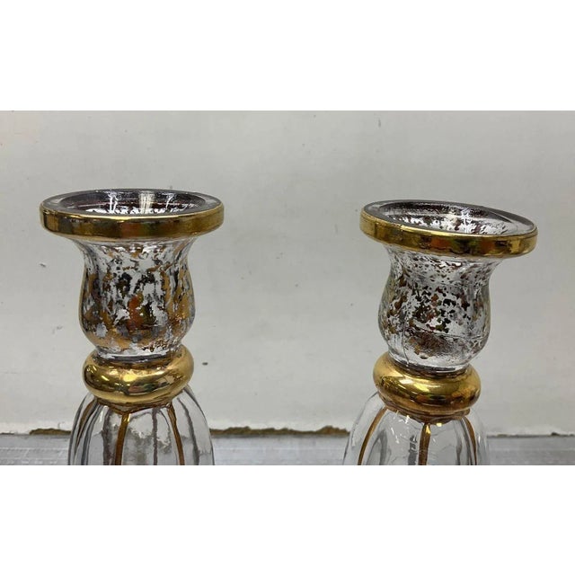 These Murano style candle holders were made in Italy by Cristallerie. There is a stamp on the bottom. The glass has gold...