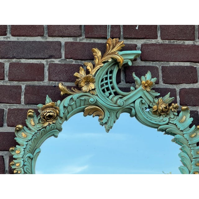 A decorative 1940 French Louis XVI-style wall mirror, beautifully refinished in an antique green Trianon tone with gold...