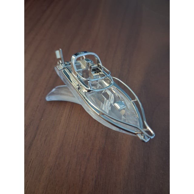 Swarovski Crystal Memories Power Boat figurine (Swarovski part number 272554). This collectible piece features a clear...