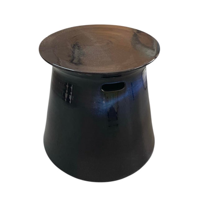 A sculptural accent piece, this contemporary side table is handcrafted in Italy from high-fired ceramic. It features a...