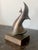 This nicely stylized seagull and wave sculpture, with its crescent body, arched wing and simplified head, reflects the...