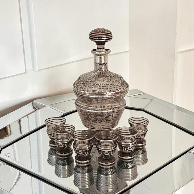 This probable Czech/Bohemian crystal decanter and cordial set was produced in Czechoslovakia during the Mid 20th Century,...
