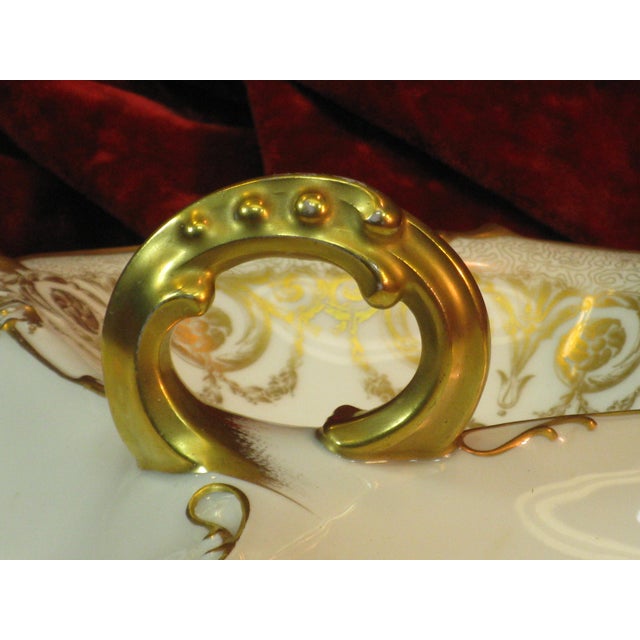 The Serving Dish 8JPL POUYAT Limoges is an antique hand-painted porcelain dish from the 1900s, featuring a unique...