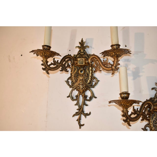 Pair of vintage Halcolite wall sconces. Gorgeous casting and quality made from brass. Each sconce has a wonderfully...