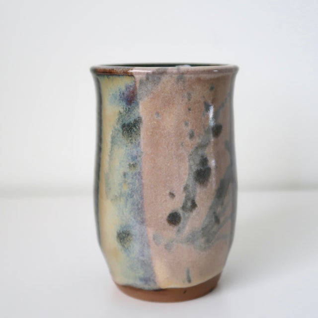 Handmade studio pottery ceramic vessel featuring a richly layered earth-tone glaze with painterly bands of moss green,...