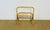 A charming rattan magazine rack dating from the 1960s. it rests on four crossed legs and has an integrated handle. the...