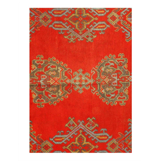 Showcasing a bold expressive design with incredible detail and texture, this hand knotted wool antique red Oushak rug is a...