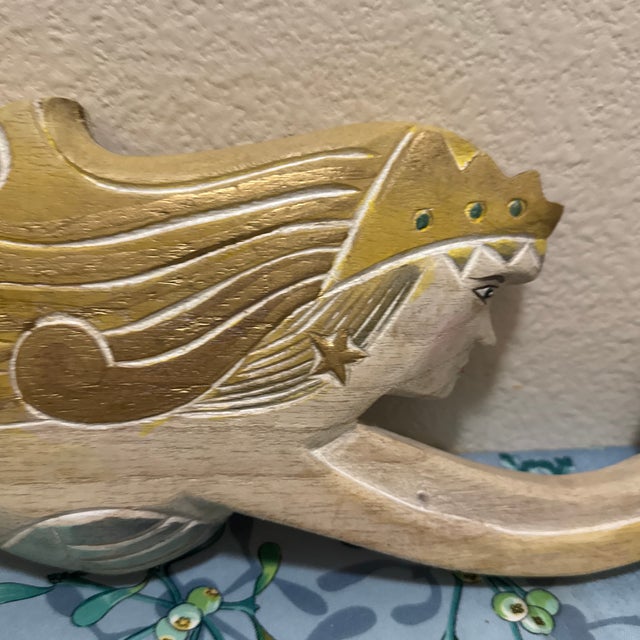 This hand-carved and hand-painted wooden mermaid wall sculpture is a classic piece of nautical folk art.