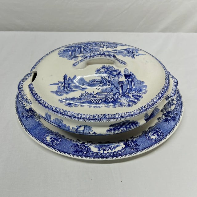 Large Blue transferware tureen and underplate. Marked Estatua, Gilman & CTA, Portugal. Underplate measures 14.5” w x 11.5”...