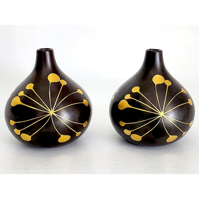 Offered is a pair of burnished glaze ceramic bud vases in a deep espresso almost black color with a striking brass inlay...