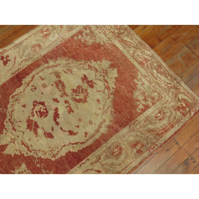 One of a kind, early 20th-century Hand-knotted wool Turkish Runner with an open field 3 floral medallion design on a pale...