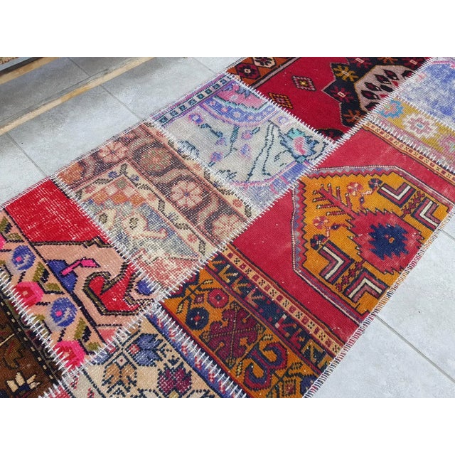 This is a vintage Turkish Oushak rug from the Mid 20th Century. The piece was hand-knotted.