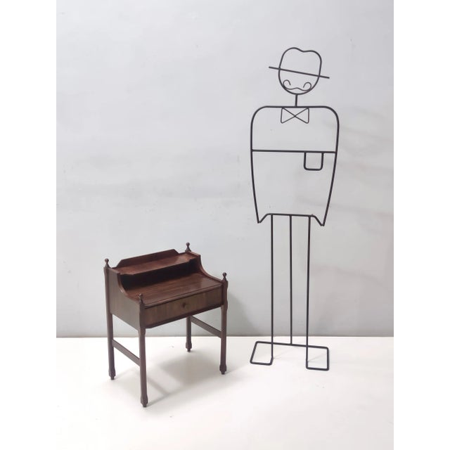 Made in Italy, 1970s. This nightstand features a walnut frame. It might show slight traces of use since it's vintage, but...