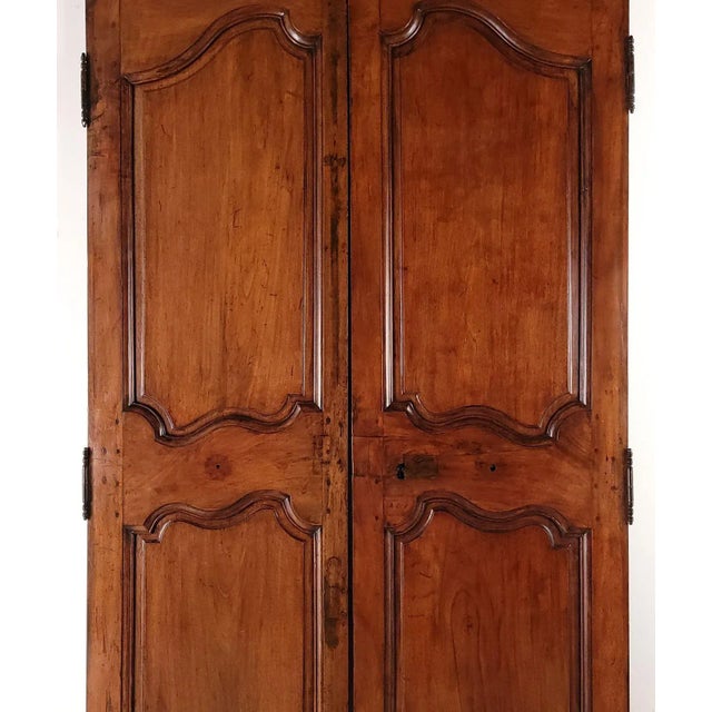 A pair of walnut doors, France, 19th century or earlier. Some old repairs. Impressive & sophisticated.