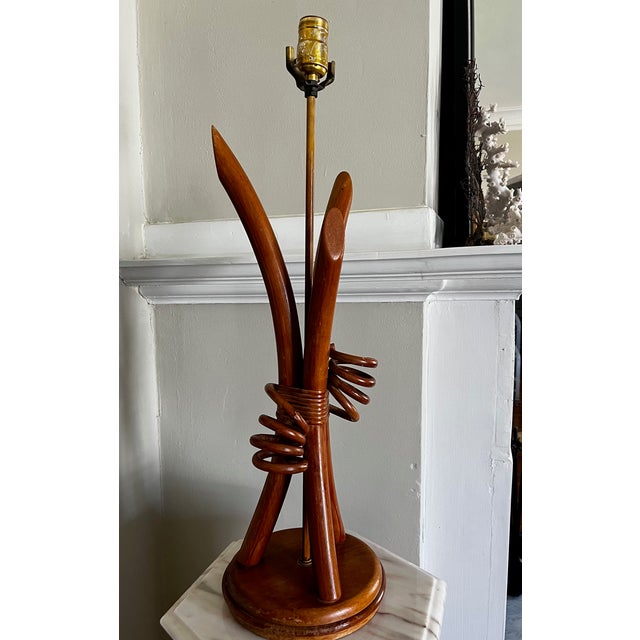 Striking hourglass lamp with rattan accents. Dramatic details and sculptural shape make this one a standout.