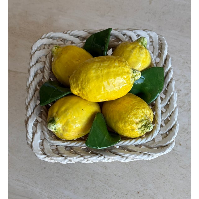Vintage Italian ceramic centerpiece in the form of a footed basket filled with lemons. The bowl is hand-woven from ropes...