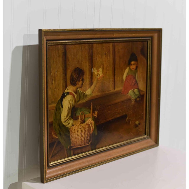 This charming Mid Century oil painting captures the bond between a mother, child, and highlights their cherished lamb toy....