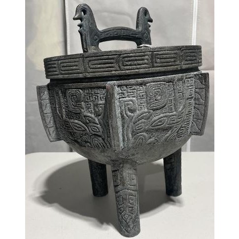 A sculptural mid-century ice bucket attributed to James Mont, featuring an Asian-inspired form and richly textured metal...