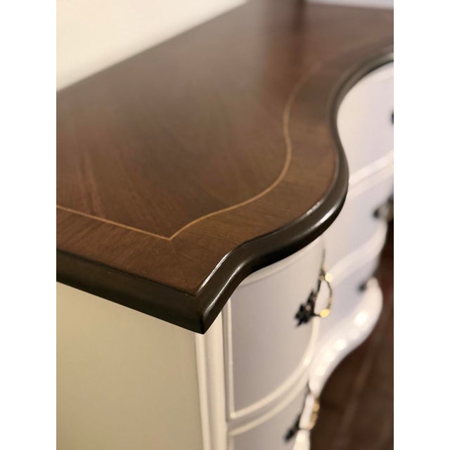 A beautiful vintage Broyhill chest featuring a graceful serpentine front, carved detailing, and classic proportions. This...