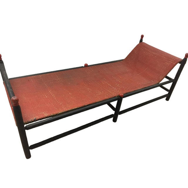This chaise, done by the Heywood Wakefield Company in the 19th century. It has original red painted caned top and black...