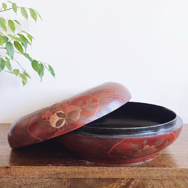 Antique early 20th Century Chinese red lacquer wood painted box. Beautiful hand-painted detail features a phoenix and...