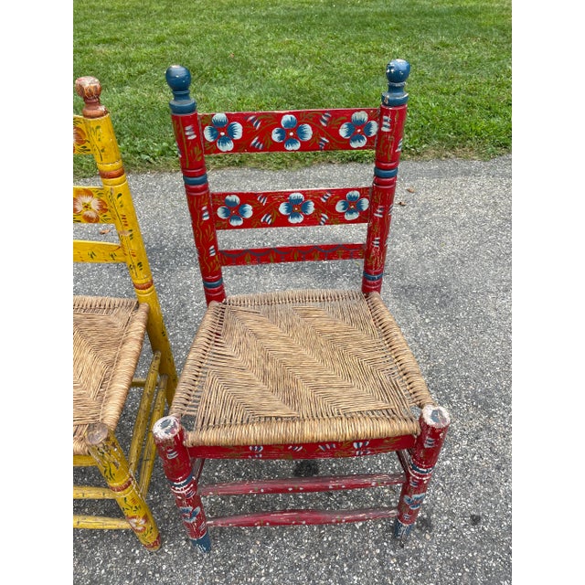 One of a kind vintage hand painted rush seat dining chairs, one yellow and one red. Intricate rush weaving on seats,...