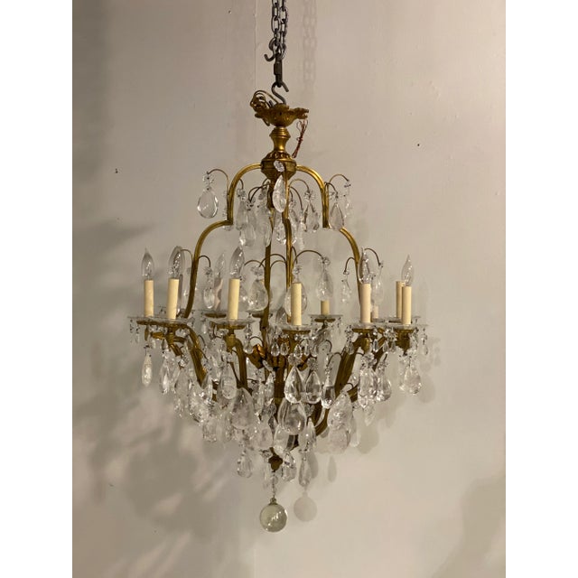 A circa 1900 French gilt bronze chandelier with 12 lights + 6 interiors, rock crystals pendants