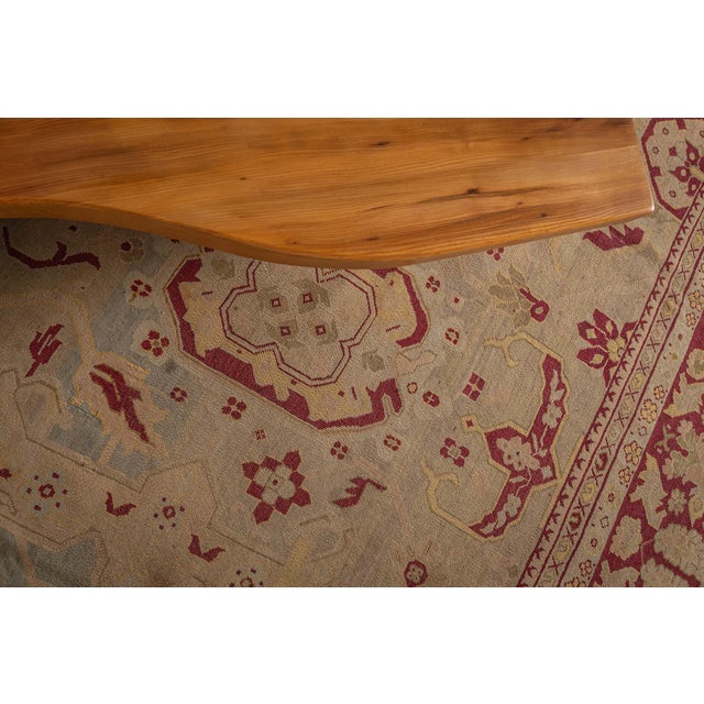 An early 20th century Indian Agra carpet, the taupe field with primitive allover angular floral motifs in crimson, beige...