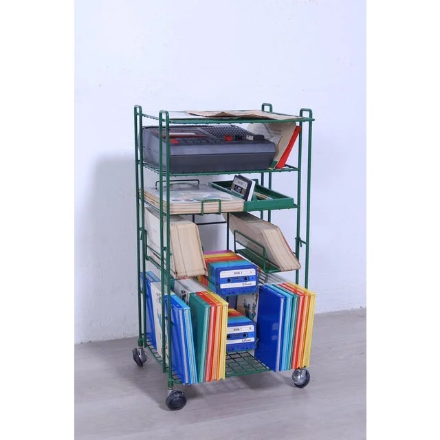 Green color enameled metal cart with four well-functioning wheels. Design Bruno Munari, realization G. De Marco,...