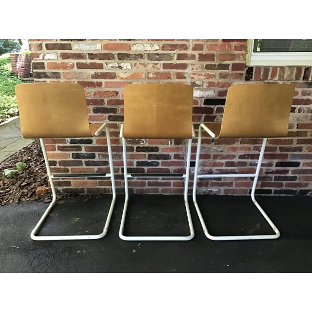 This rare set of three unique midcentury bent plywood bar stools would make a nice addition to any bar, whether in a...