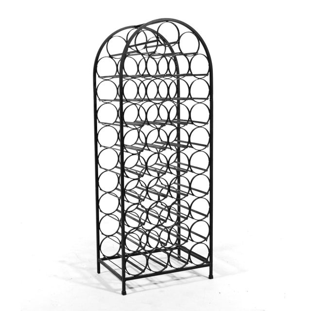 Ready to hold 39 wine bottles, this iron wine rack by Arthur Umanoff has a delightful curved top echoing the round shape...
