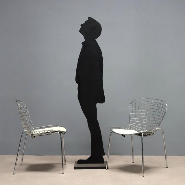 Set of ten vintage chairs with chromed metal frame, original cushions in shades of white. This piece is attributed to the...