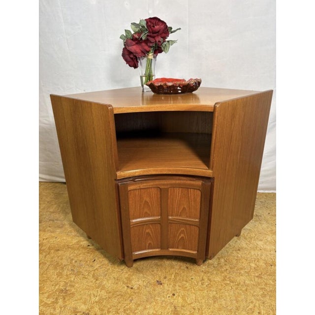 A beautiful and highly practical vintage teak corner cabinet by nathan furniture, dating from the 1960s–1970s. Crafted in...
