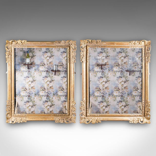 This is a large pair of antique wall mirrors. An English, giltwood dressing or valet mirror, dating to the Regency period,...