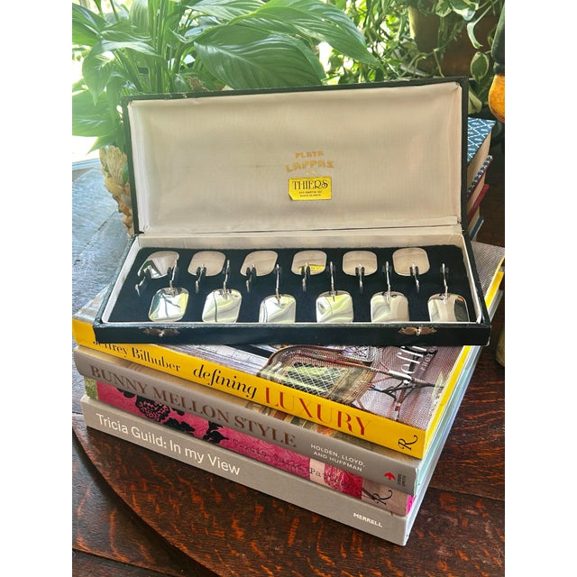 Elevate your table with this elegant set of twelve modernist silver-plated knife rests by Plata Lappas S.R. of Argentina....