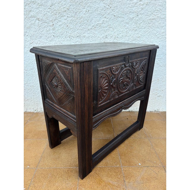 Striking Spanish carved wood chest from the early 20th century, inspired by Renaissance Revival design. This piece...
