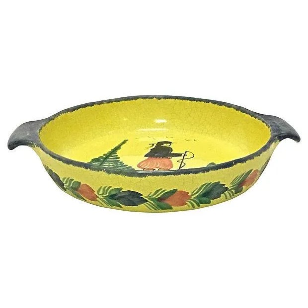 Vintage, French, Quimper, hiker, serving bowl with handles. Depicts a hand-painted hiker figure at the center with floral...