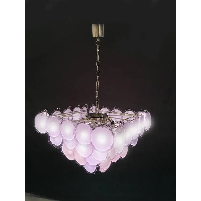 The chandelier is made of 52 discs of precious Murano glass are arranged on four levels. Nine E14 lights. Available four...